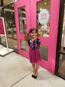 Coppelia's daughter excited to go in to the party at Charming Charlie
