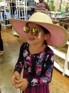 Coppelia's daughter loving her Charming Charlie hat and sunnies