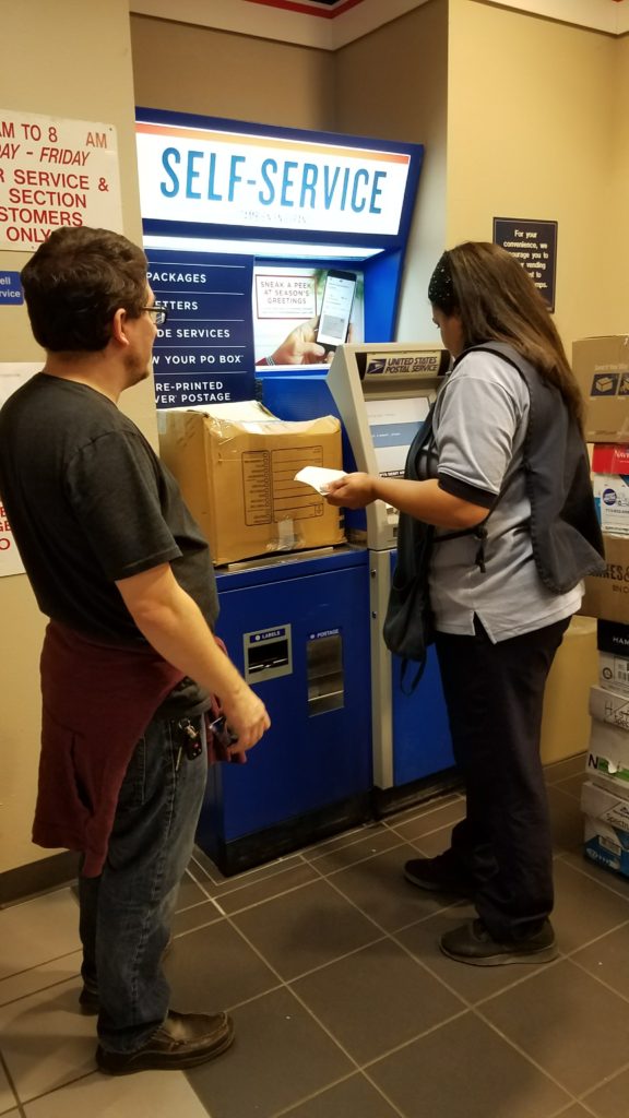 Steven and Crystal at the US Post Office self service shipping boxes to Puerto Rico