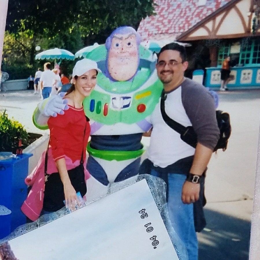 Happy couple, Coppelia and Adam, with Buzz Lightyear at Disney World! 