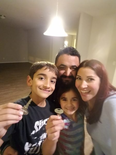 Smiling family with the keys to the new house!