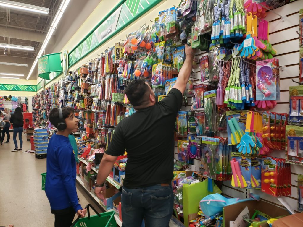 Operation Christmas Child dad shopping with kids for toys to pack a shoebox!