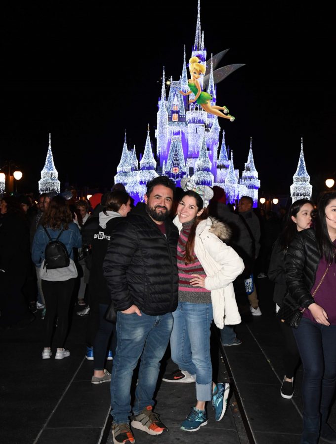 Couple in front of Cinderella's Castle at Disney's Magic Kingdom with Tinkerbell