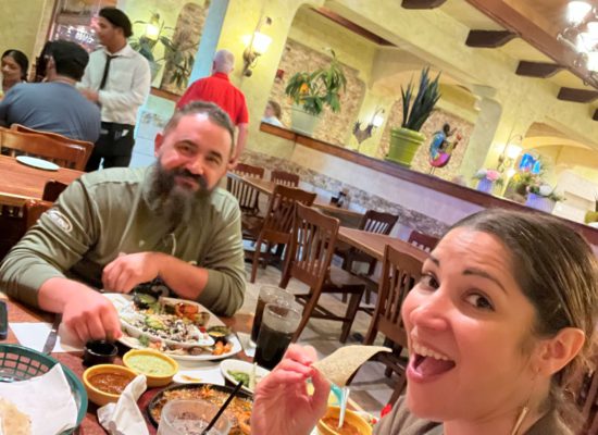 Smiling latino husband and wife enjoy date night at a mexican restaurant